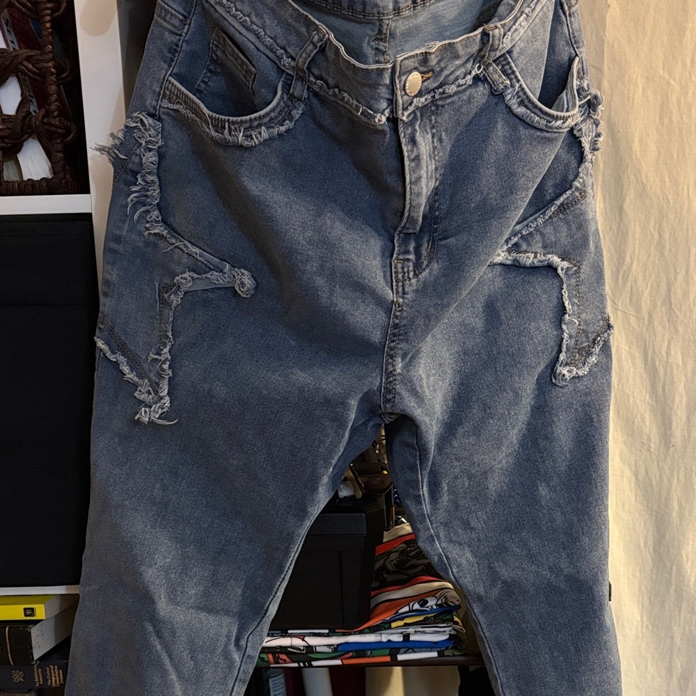 SHEIN Curve Distressed Blue Flare Jeans for Women.
